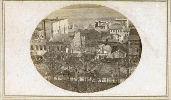 First block of East Main street photographed from the roof of the Wisconsin State Capitol building. Doty and Wilson street properties and Lake Monona are in the background.