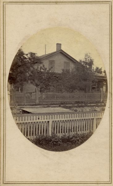 Exterior view of a Madison residence enclosed by a fence.