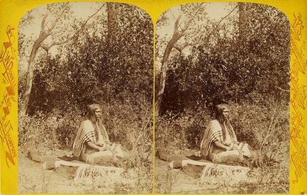 Stereograph of Tau-ruv seated on a blanket.