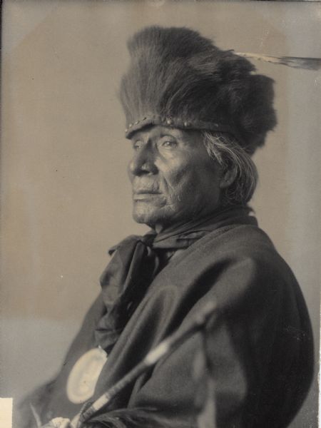 Studio portrait of Ponca man, Mon-chu'-hin-xte or Hairy (Grizzly) Bear, chief, wearing a medal. Part of Siouan (Sioux) and Ponca Tribes.