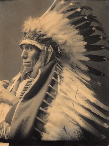 Portrait (Profile) of Peter Tall Mandan, Grandson of Long Mandan, in native dress with headdress and breastplate. Part of Siouan (Sioux) and Brule Tribes.

