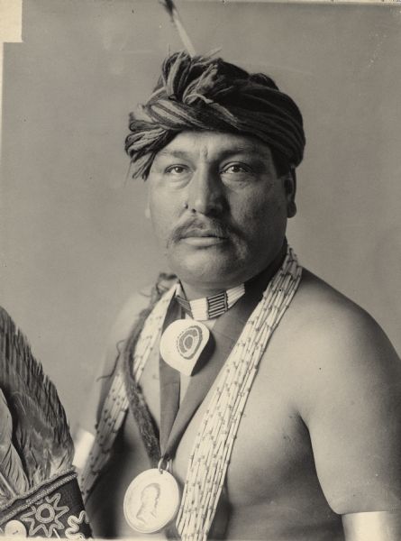 Studio portrait of Iowa man, Joseph Springer. Part of Siouan (Sioux) and Iowa Tribes.
