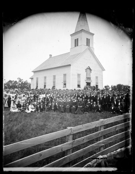 The congregation of the East Blue Mounds Lutheran Church and visiting ministers are gathered for the church dedication. The church was formerly Norsk Evangelisk Kirke, built in 1868.