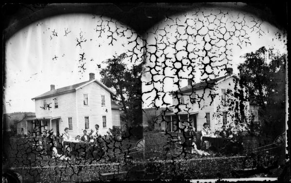 The family of the Reverend John N. Fjeld (1818-1888) sits at a table in front of their wood frame house near the Vermont Lutheran Church. His wife Gunhild, who died in 1877, is on the left. It may be his second wife Ingeborg Belgium standing behind him. They married in 1879.