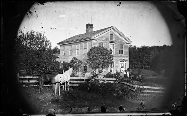 A Yankee-built Greek Revival frame house from the 1840s. The small dark rectangular plaque above the door is a Madison Mutual Insurance Company sign that informed volunteer fire fighters that their services would be fully compensated in the event of a fire. This company was founded in 1851 by a group of Yankee businessmen. Its main competitor, as represented in Dahl's pictures, was the Hekla Fire Insurance Company of Madison, a Norwegian-American enterprise.