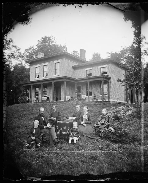 Halle Steensland and his wife Sophia pose with their five children (left to right: Morten, Henry, Edward, Halbert and Helen) in front of their home in Maple Bluff.