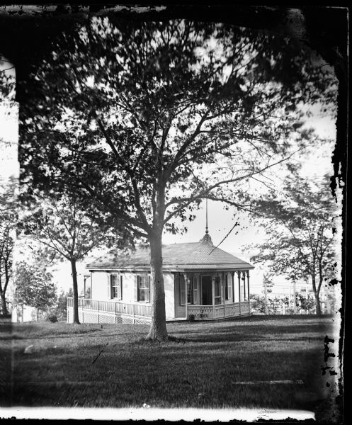 Ole Bull Residence Billiard Hall behind his house, 130 E. Gilman Street. Frame building with railing on side and latticework on bottom, with shutters and cut work on small front porch railing. Later, the house was known as the Thorp House. It became the executive mansion for the governor of Wisconsin in 1885 and the University of Wisconsin Knapp Graduate Center after 1950.