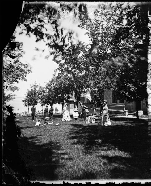 Ole Bull Residence at 130 East Gilman Street. Family on lawn playing croquet with house in background. Later, the house was known as the Thorp House. It became the executive mansion for the governor of Wisconsin in 1885 and later the University of Wisconsin Knapp Graduate Center.