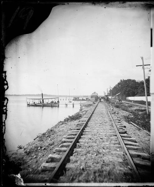 View down railroad tracks at Angle Worm Station alongside Lake Monona. The station's unusual name originated from a speech given by Captain Frank Barnes every Fourth of July on how civilization was dependent on the lowly earthworm.