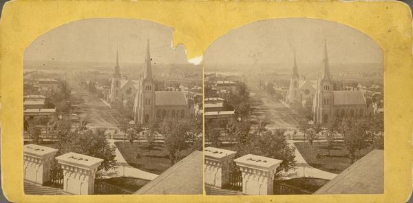 Elevated view looking down West Washington Avenue at the Congregational Church (on the left) and the Grace Episcopal Church, two of the era's large and lavish churches.