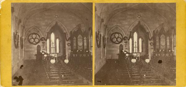 Interior of Grace Episcopal Church, decorated with garlands. This may not be a photograph made by Dahl because the size of the stereograph is uncharacteristic.