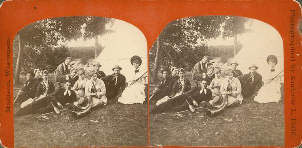 A group of campers at McBride's Point at Maple Bluff on Lake Mendota. They are equipped with German exercise equipment (exercise pins, "kegels"), a horn (like a miniature alpen horn), an axe and archery equipment.