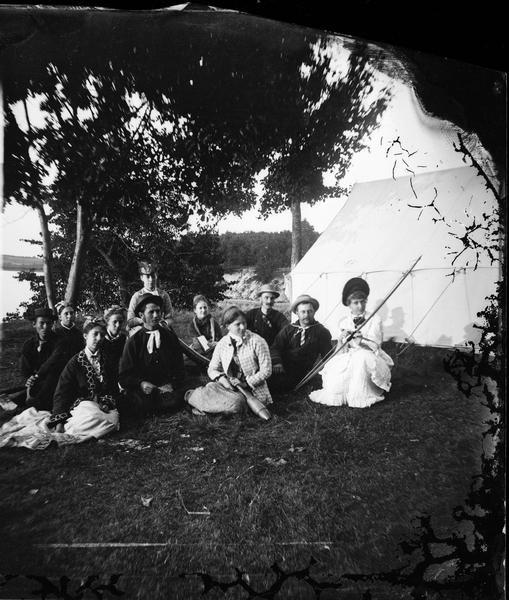 A group of campers at McBride's Point at Maple Bluff on Lake Mendota near Madison, Wisconsin. They are equipped with German exercise equipment (exercise pins, "kegels"), a horn (like a miniature alpen horn), an axe and archery equipment.
