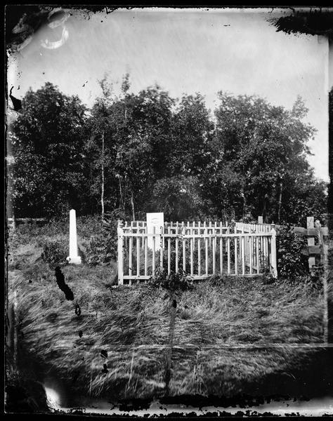 The Old York Cemetery.  The 1872 headstone of Haldor, son of Syver and Martha Holland, is in the foreground, surrounded by a picket fence.
