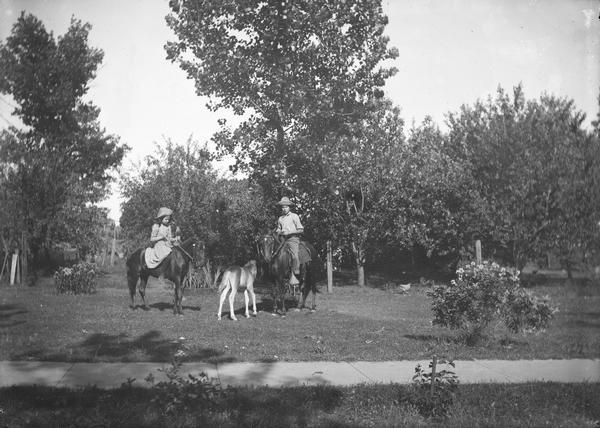 Walter Dahl and girl on separate horses, with colt.