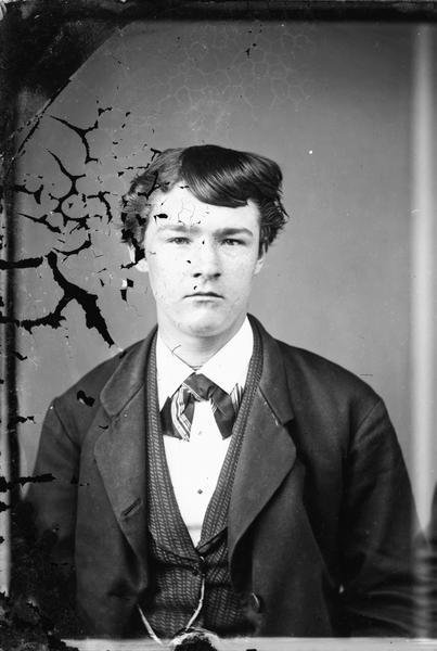 Portrait of a young man in vest and tie.