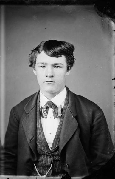 Portrait of a young man in vest and tie.