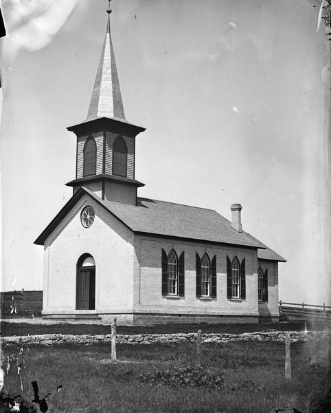 Lodi Norwegian Evangelical Lutheran Church, built in 1872 for three thousand dollars.  A circular stained glass window is in the front of the building above the entrance.  The church is now the Arlington Lutheran Church.