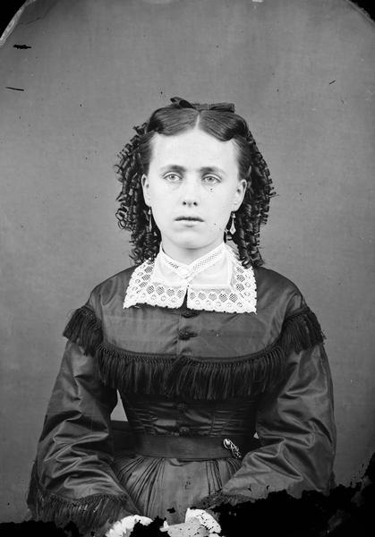 Portrait of an unidentified young woman with clear view of bodice trim, lace collar and jewelry.