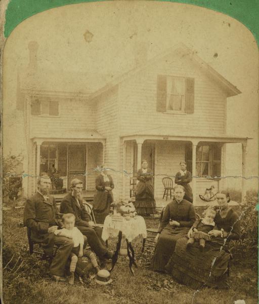 The right half of an albumen stereograph of the Dahl and Amundsen families in front of the Amundsen home in Lodi, Wisconsin. From left to right seated are Andrew Dahl, his father-in-law Andrew Amundsen, his mother-in-law Gjertrud Amundsen and his wife Gjertrud Amundsen Dahl.