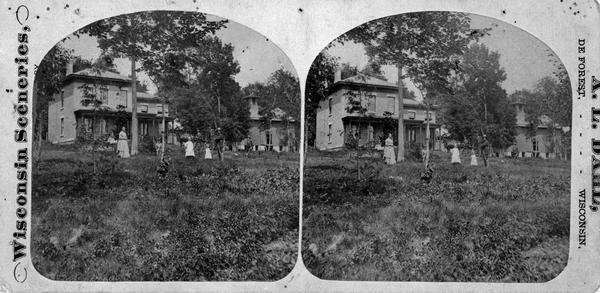 Halle Steensland and his wife Sophia posing with their five children at the family home, later located at 733 Lakewood Boulevard, Village of Maple Bluff. There is also a carriage and an outbuilding, probably a carriage house. (The house and farm were later owned by Robert M. La Follette, Sr.)
