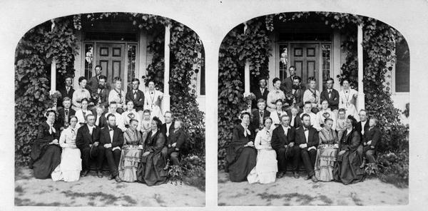 "Rev. J.A. Ottesen, family and family group on the veranda" from Dahl's 1877 "Catalogue of Stereoscopic Views."  First row left to right: Mrs. Ottesen, Froken Larsen (late Mrs. Krohn), Rev. Ottesen, Rev. Krohn, Froken Normann, Mrs. H.A. Preus, Rev. L.A. Preus. Second row: Otto C. Ottesen, Agnes Preus, "Dr." Wilhelm Preus, Hannah Ottesen, unknown. Standing: O.J. Felland, Rosine Pauline Keysr Preus (late Mrs. Nordbye), Dr. Magelssen, Dikka Ottesen, C.K. Preus, Henrietta (?) Korni.