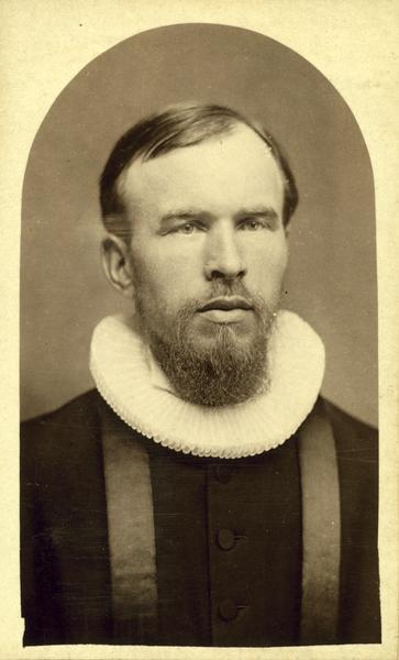Studio portrait of the Reverend Andreas Larsen Dahl, pastor of the Holden Lutheran Church in Mt. Morris, Waushara County, Wisconsin, from 1883 to 1912. Dahl was born in 1844 in Valdres, Norway, immigrated to the United States in 1869, and worked as a photographer from 1869 to 1879. He became a Lutheran minister in 1883 and served his church in Wisconsin, North Dakota and Minnesota. He died in 1923.
