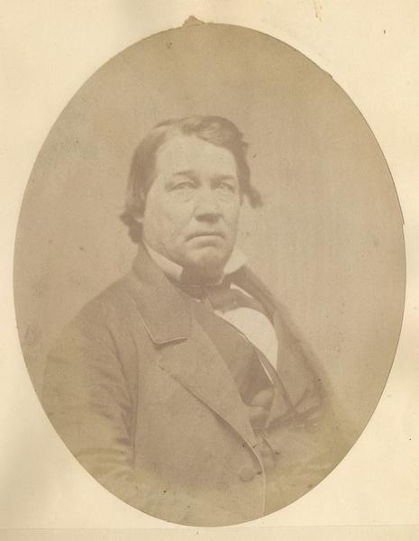 Waist-up oval portrait of J.H. Smalley. He was born in Hyde Park, Lamoil County, Vermont in 1816, and came to Wisconsin in 1835. He moved to Green Bay in 1836, and later resided in Oshkosh.