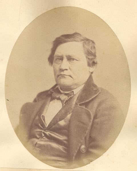 Waist-up oval portrait of Jacob Gundlach.  He was born in Kuhr Hessen, Germany, and emigrated to Wisconsin in 1832.  In 1851, he became one of the first settlers in Germantown.