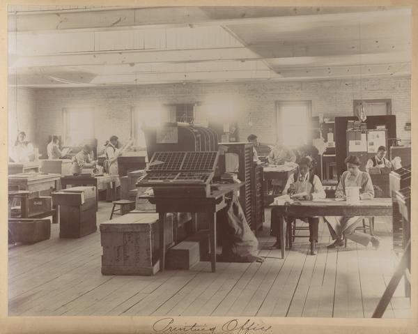 Students working in a printing office at the Indian Industrial School.