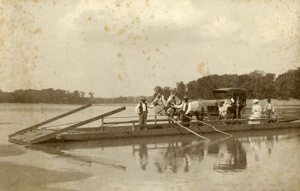 A passenger ferry, possibly on the Arkansas river.  Passengers include men, women, and horses.