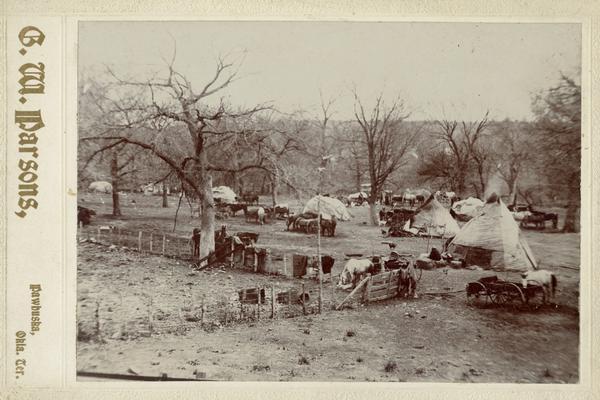 Osage tepees, horses, and wagons.
