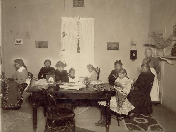 Women and girls sewing in a room at the Pima Agency, near Phoenix.
