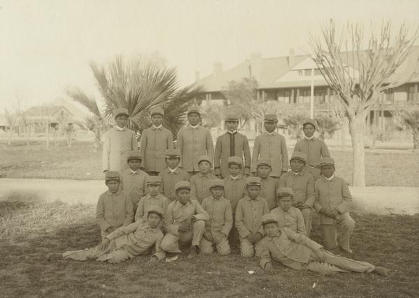 A group of Pima Agency male students on agency grounds.