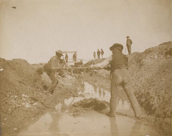 San Ildefonso Pueblo workers digging a ditch.