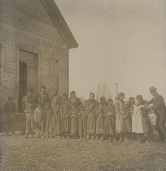A public school at Wushakie, Utah, composed entirely of Mormon Indians and the missionaries' children.  The teacher is on the right.