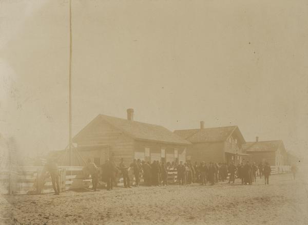 A group of Native Americans gathers, possibly during council at the Leech Lake Agency.  This image is part of a collection of images of the Ojibwa-Pillager Battle at Sugar Point on Bear Island.