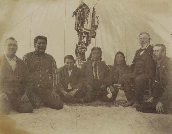 Indian Court, with interpreter Charlie Pitt; police captain Antwine Pepins, Judge Thomas Palmer; Chief Judge Albert Kuckup (captor of Captain Jack, Madoc Chief); Nina Patt, soldier in the Snake War; supervisor A.O. Wright; and the Chief of Police.  This image is part of a series of images of the Warm Springs Agency in Oregon.