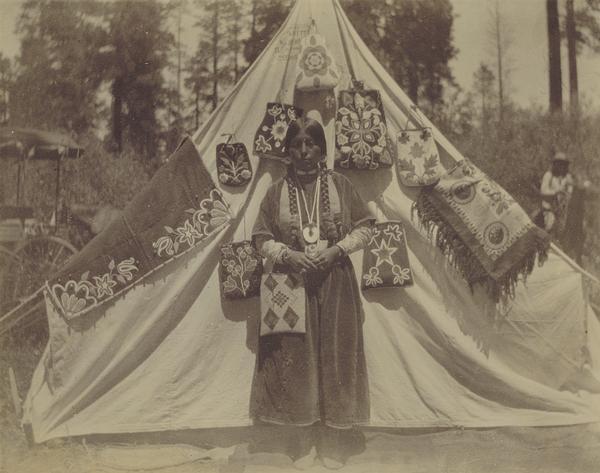 A woman with appliqued and beaded bags at the Warm Springs Agency in Oregon.