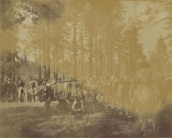 Indians gamble while many spectators on horseback look on at the Warm Springs Agency in Oregon.