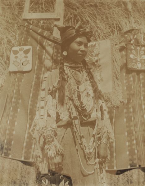 Charlotte Edwards, an Indian girl, in full buckskin dress at the Warm Springs Agency in Oregon.