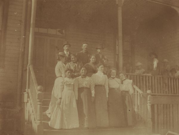 A group of school employees poses on dormitory steps at the Warm Springs Agency in Oregon.