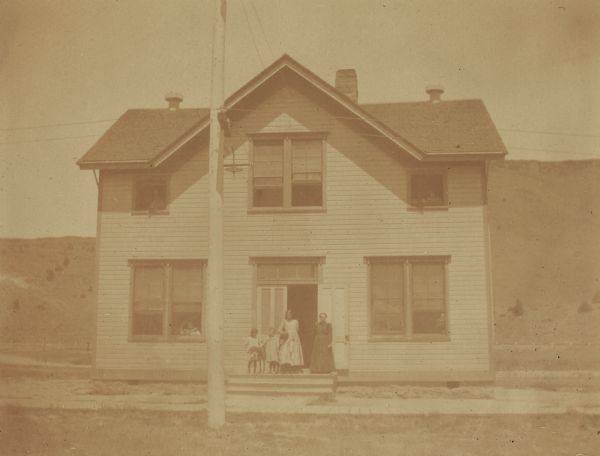 A school hospital at the Warm Springs Agency in Oregon, with Mrs. Smith, the nurse, standing in front.