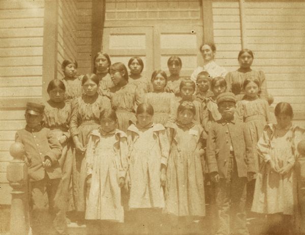 Mrs. Moors, a school teacher, with both of her classes at the Warm Springs Agency in Oregon.