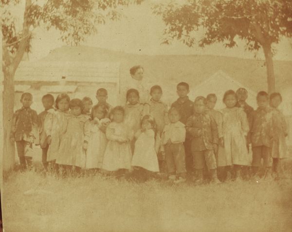 Miss Stalter, a teacher, with both of her classes in the park at the Warm Springs Agency in Oregon.