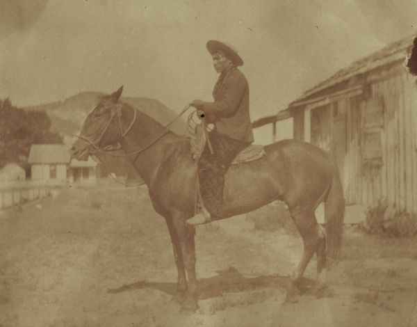 Left side view of Cain Brunoe, an Indian "cowboy," sitting on horseback at the Warm Springs Agency.