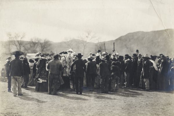 A group of people watches an event, possibly put on by the Tarahumara Indians in Mexico.