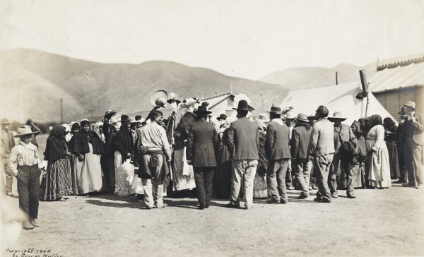 A group of people watching an event, possibly put on by the Tarahumara Indians in Mexico.
