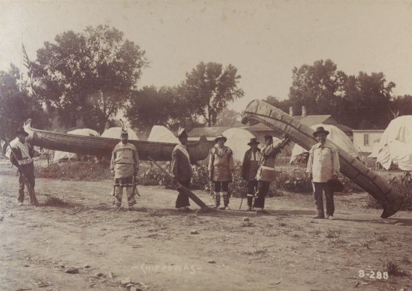 Chippewa (Ojibwa) men with canoes at the Trans-Mississippi Exposition and Indian Congress.