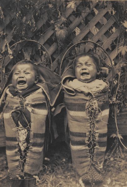 Crying Cayuse infants wrapped in Pendleton blankets.